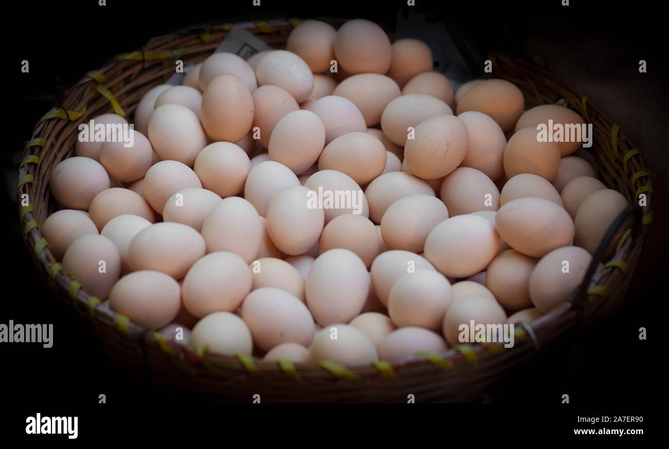 Basket of fresh organic eggs at the local market Stock Photo