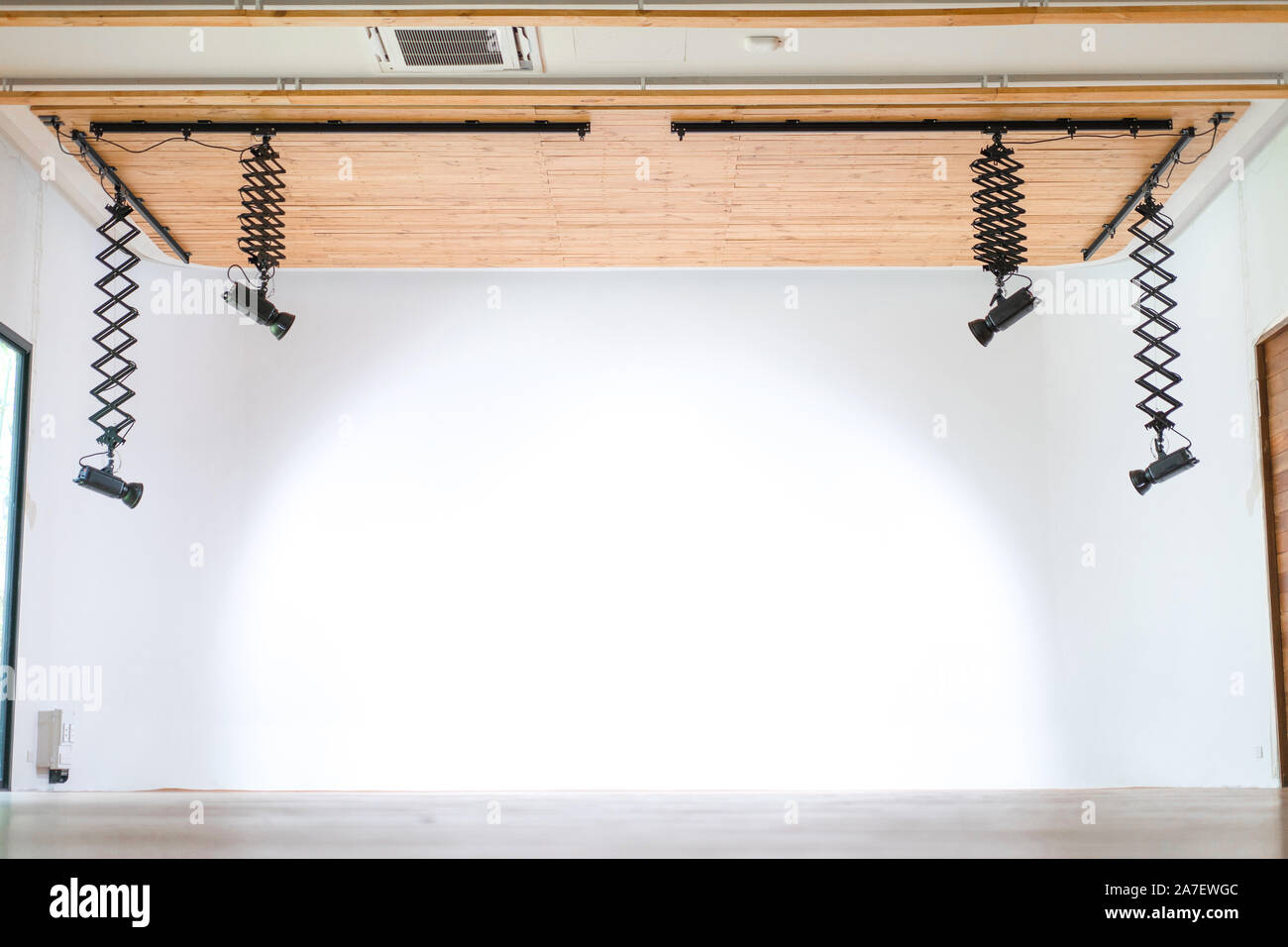 The professional studio hall hang the LED light form wood ceiling with the  infinity white wall behind Stock Photo - Alamy
