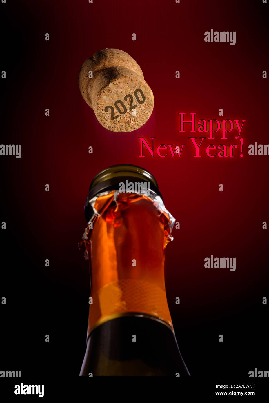 Bottle of Champagne and popping cork with  2020 written on it for new year two thousand eighteen Stock Photo
