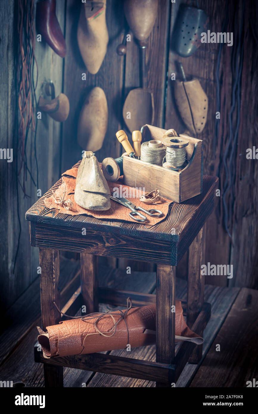 Rustic shoemaker workplace with shoes, laces and tools Stock Photo - Alamy