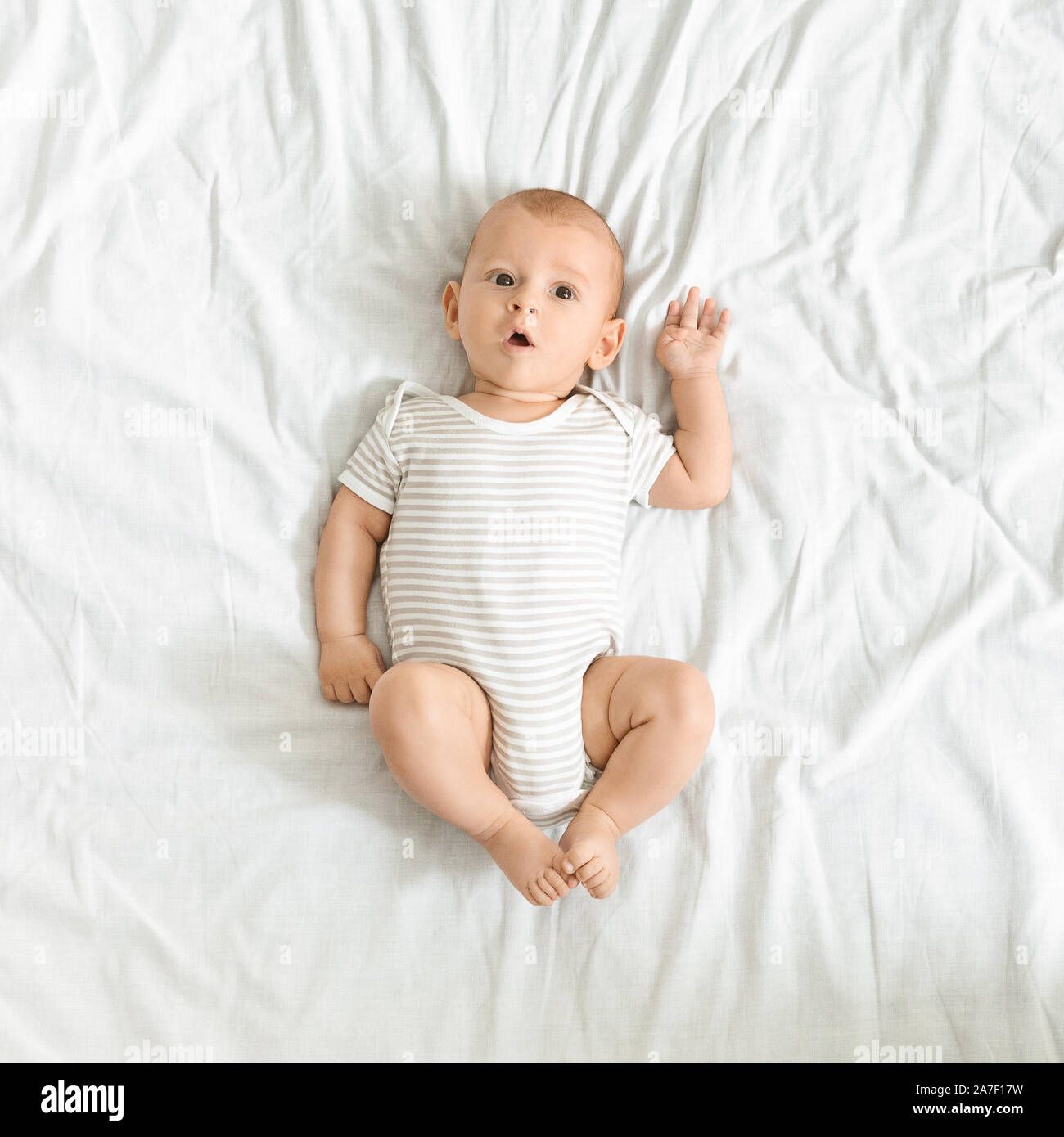Funny newborn baby in bodysuit lying on bed at home Stock Photo - Alamy Funny newborn baby in bodysuit lying on bed at home Stock Photo - Alamy