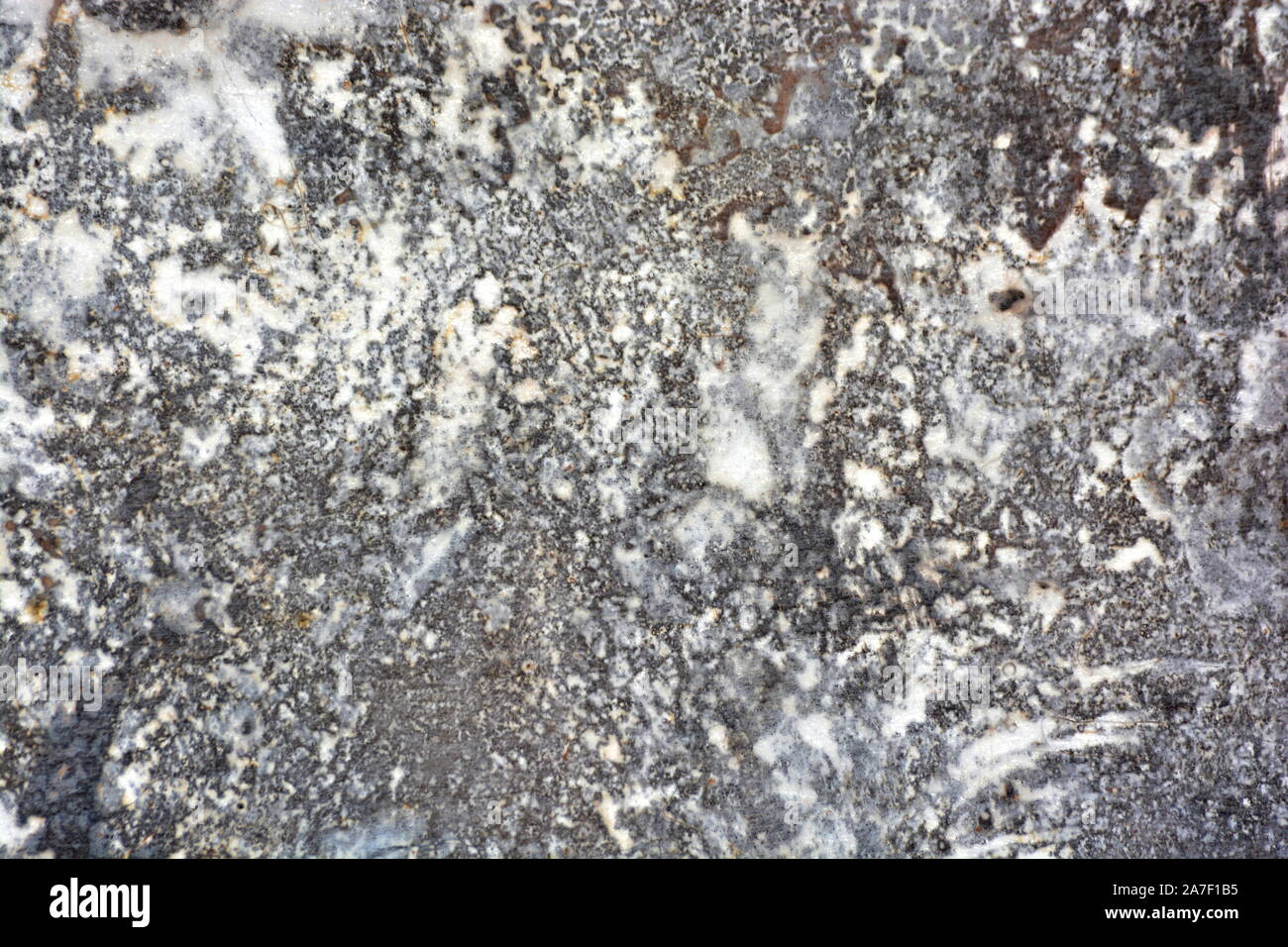 Natural granite rocks with veins of marble and minerals in intricate ...