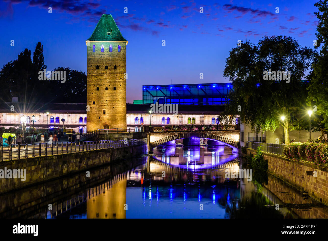 The Ponts Couverts and Vauban Dam on the river Ill in the Petite France quarter in Strasbourg, France, reflecting in the still waters at nightfall. Stock Photo