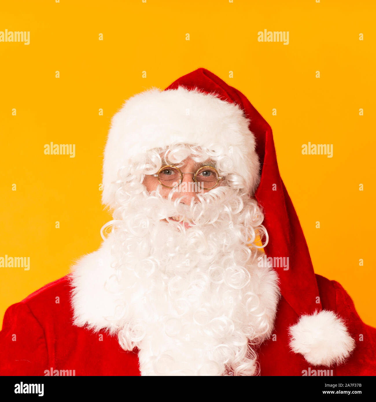 Portrait of real Santa Claus on bright orange background Stock Photo