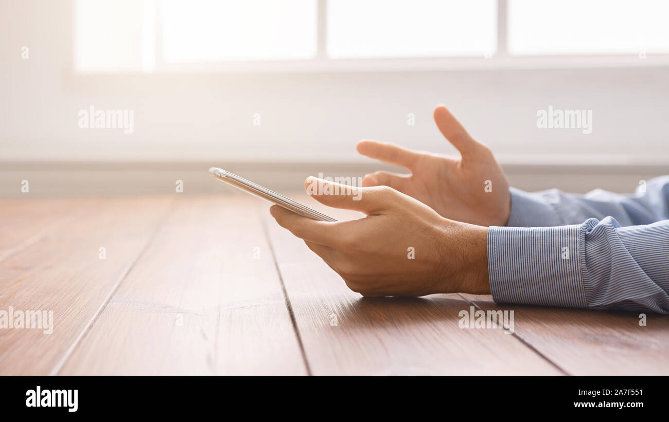 Frustrated man having problem with smartphone, closeup Stock Photo
