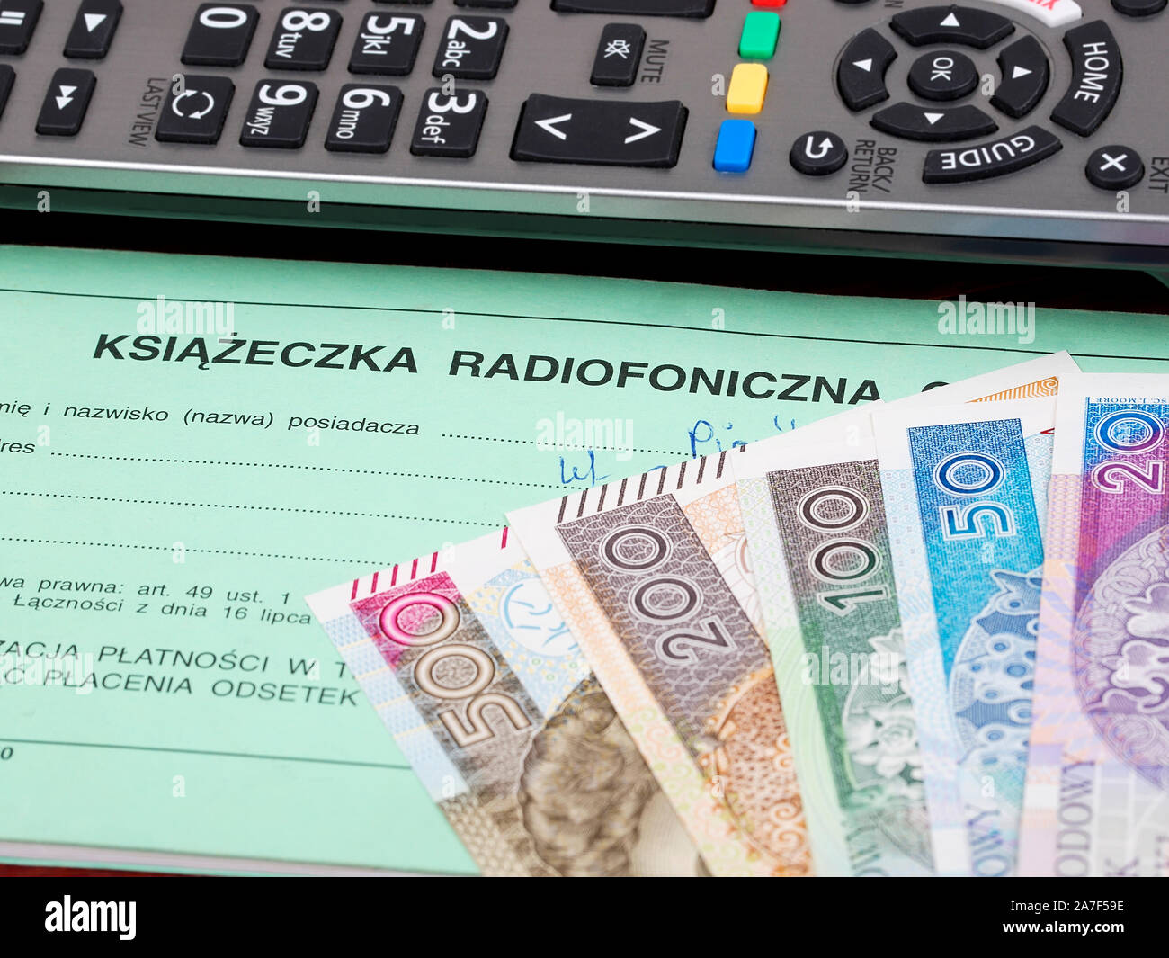 Polish TV subscription booklet with a remote control and money Stock Photo