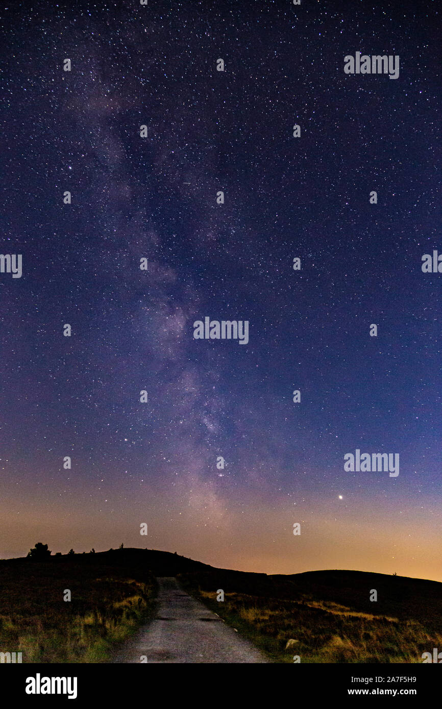 Milky way over the Clwydian Range AONB in North Wales at night Stock Photo