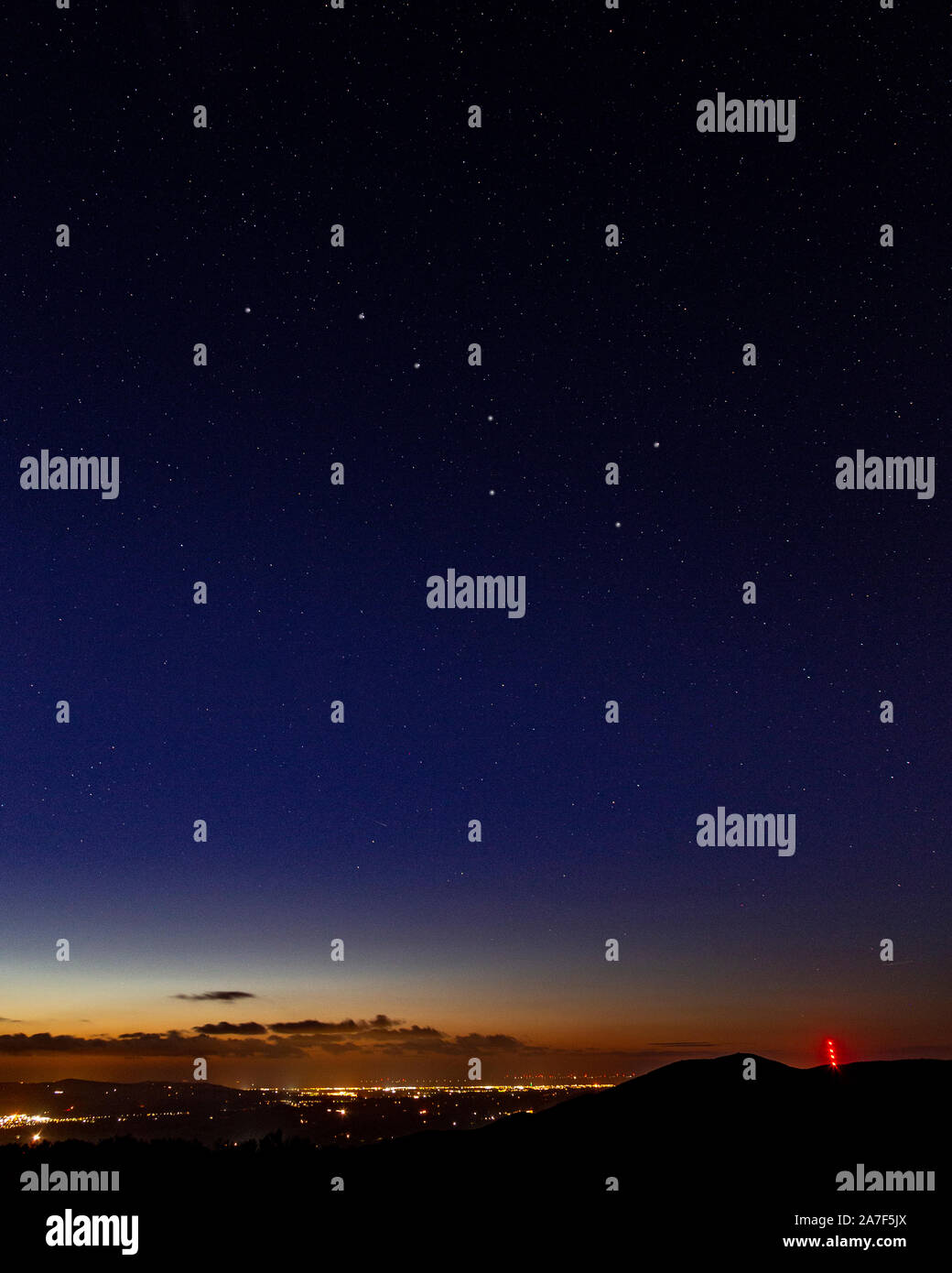 Clwydian range hills at night with stars and Moel y Parc transmitter mast Stock Photo