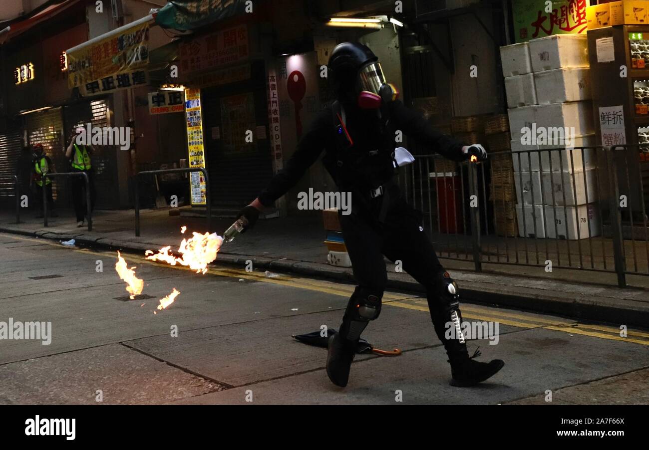 November 2, 2019, Hong Kong, CHINA: Protester throw petrol bomb at the riot police patrolling the main street from the alley.Hong Kong protests and civil unrest continue into fifth months showing no sign of dissipation.Nov-2,2019 Hong Kong.ZUMA/Liau Chung-ren (Credit Image: © Liau Chung-ren/ZUMA Wire) Stock Photo