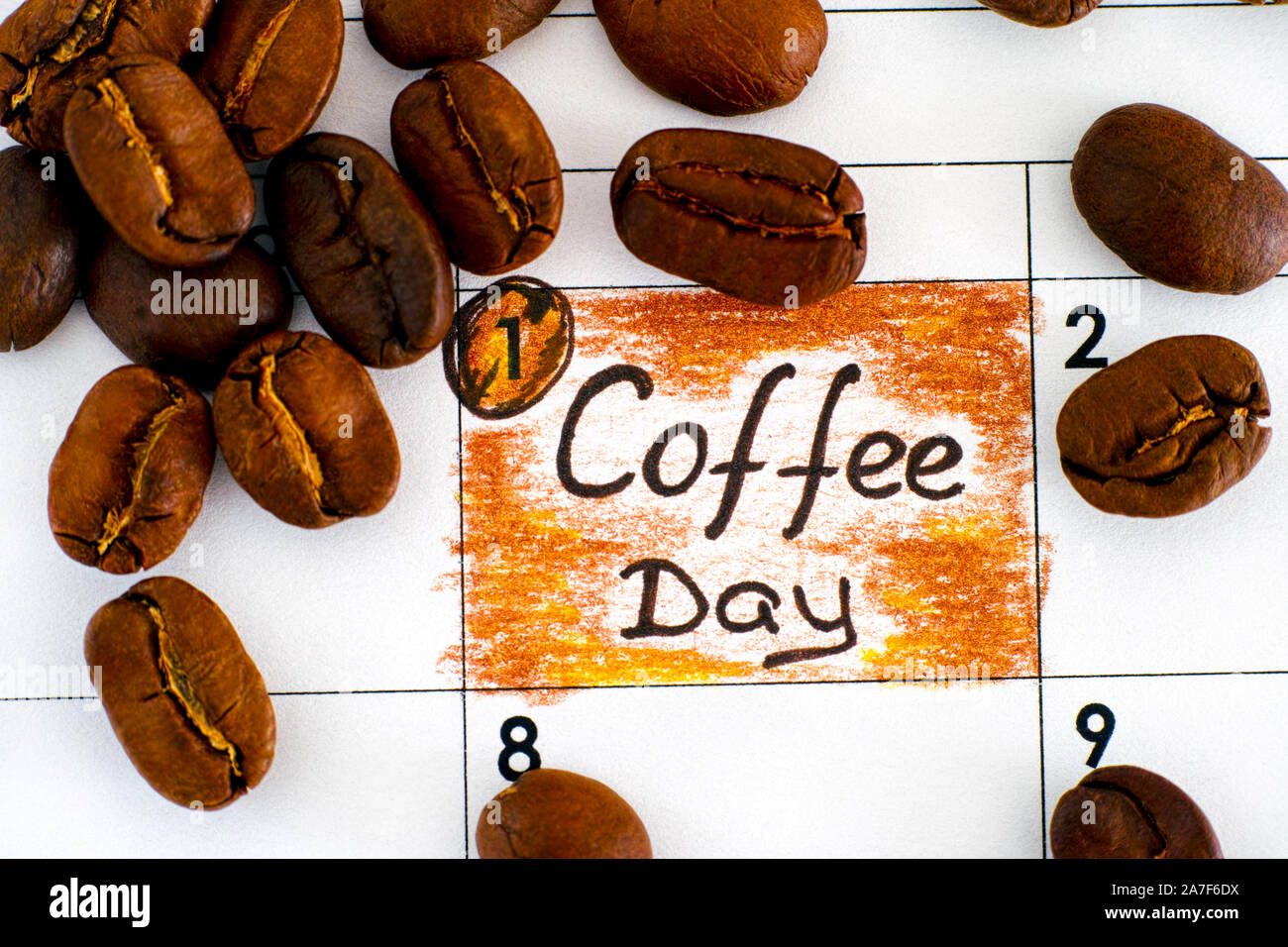 Reminder Coffee Day in calendar with some coffee beans. Close-up. Stock Photo