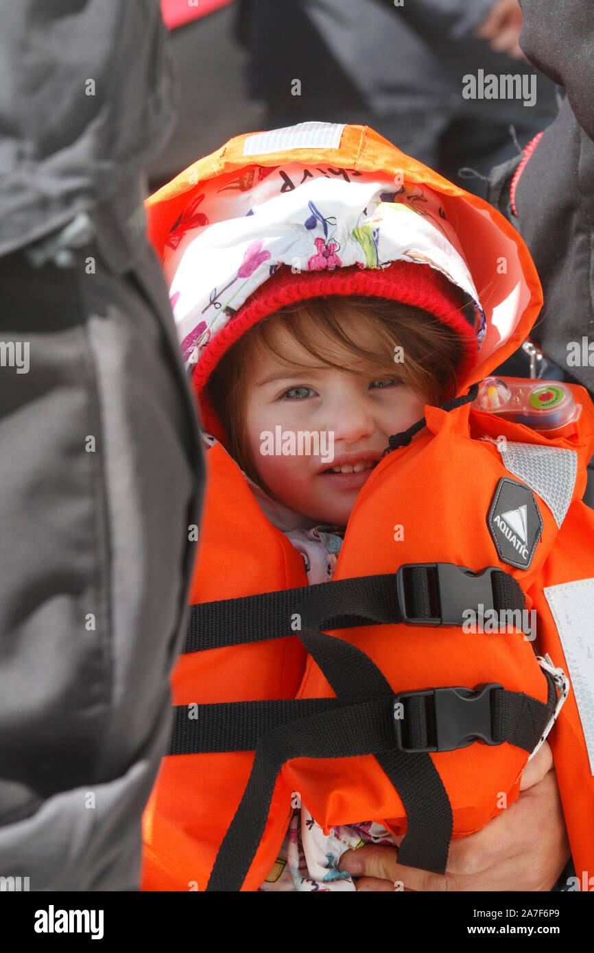 child in a life jacket on a boat trip Stock Photo