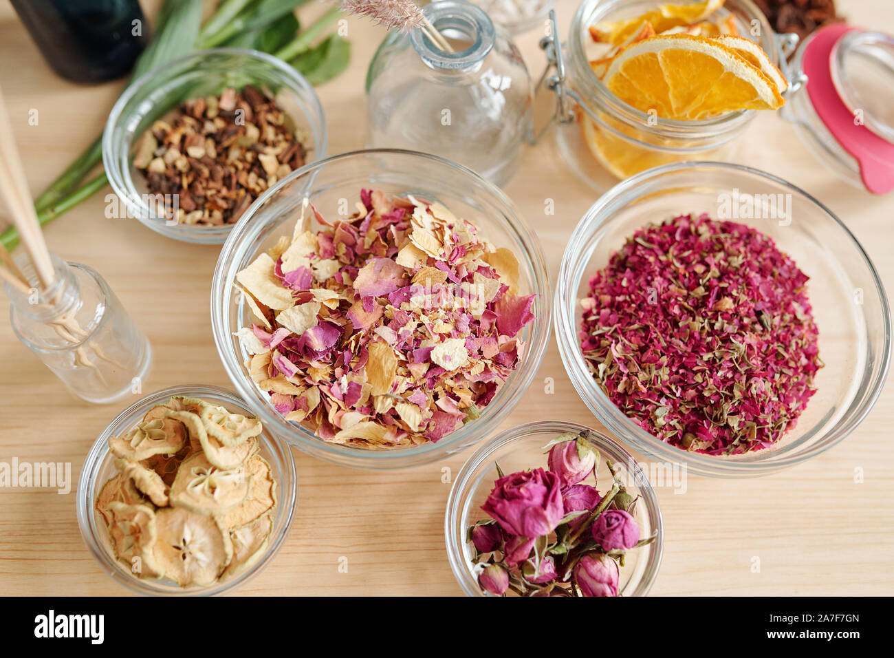Top view of aromatic stuff in bowls on table prepared for soap making