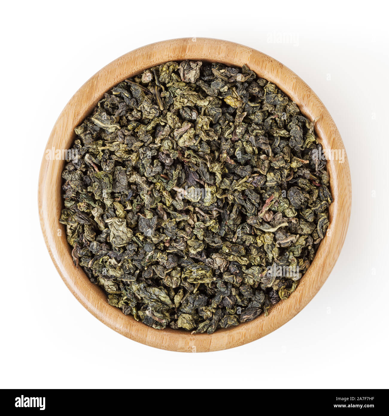 Milk oolong green tea in wooden bowl isolated on white background with