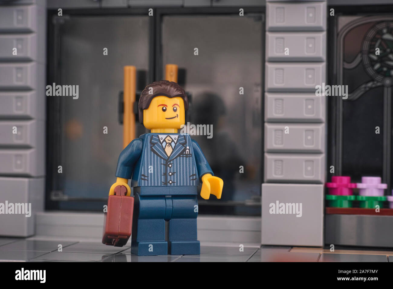 Tambov, Russian Federation - October 16, 2019 Lego businessman standing on the street in front of a bank. Stock Photo