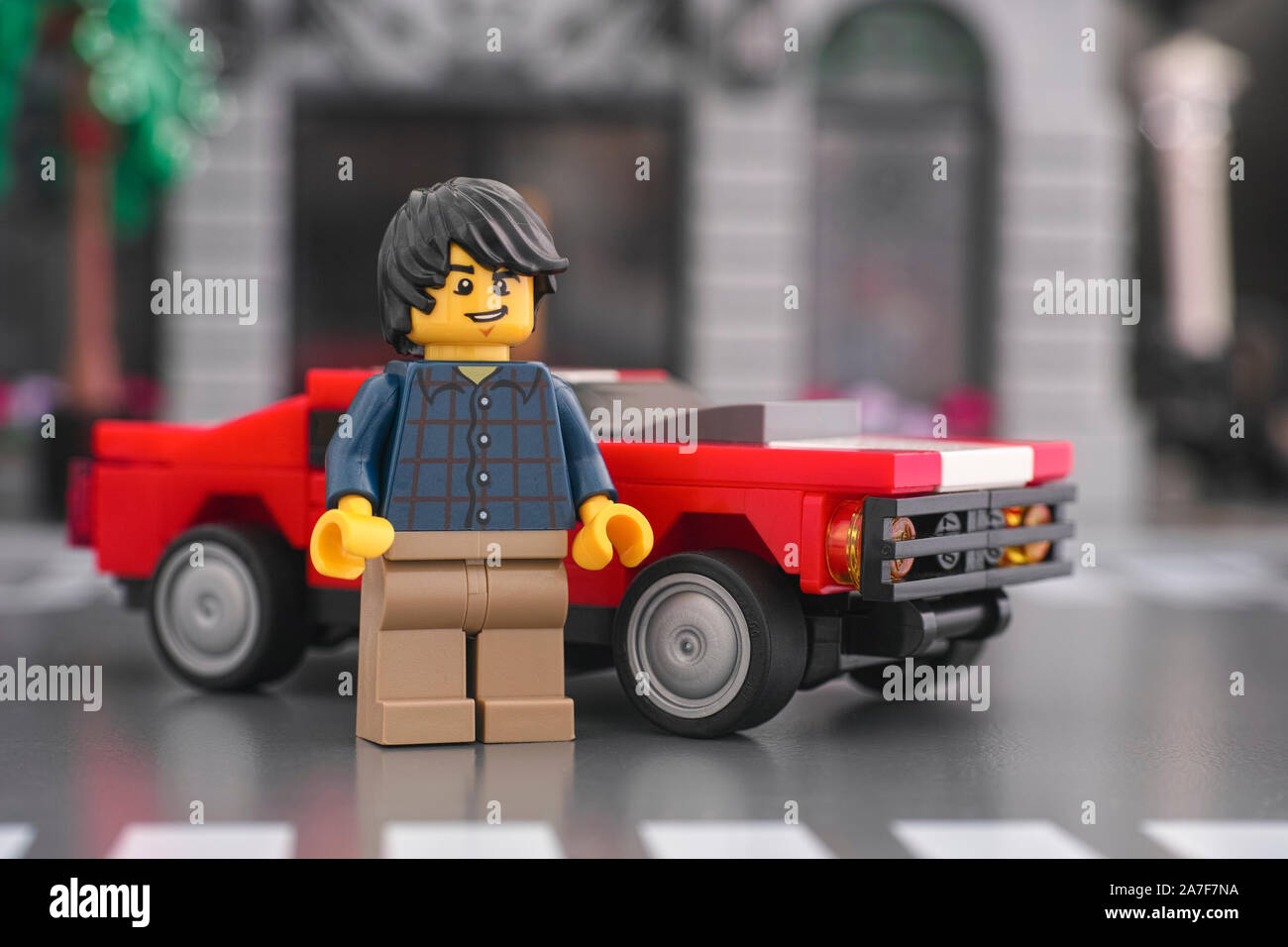 Tambov, Russian Federation - October 18, 2019 Lego minifigure standing in front of a muscle car. Stock Photo
