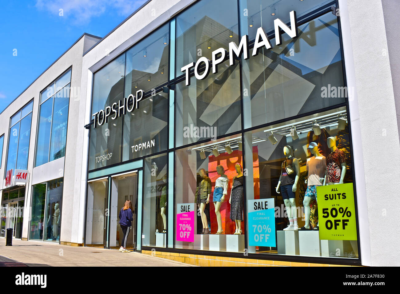 The modern front elevation of the Topshop and Topman shops in the Quedam  Centre Yeovil. Ladies & mens fashion retailer. Young woman entering store  Stock Photo - Alamy