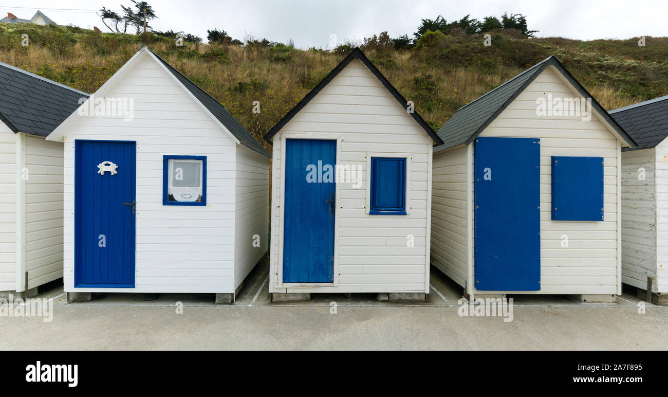 Colorful Row Of Small Wooden Beach Cottages On The Rocky Normandy