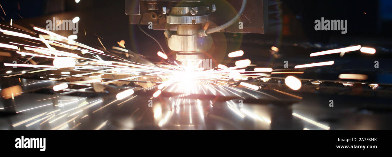 Laser metall cut cnc machine. Fly fire sparks background. Stock Photo