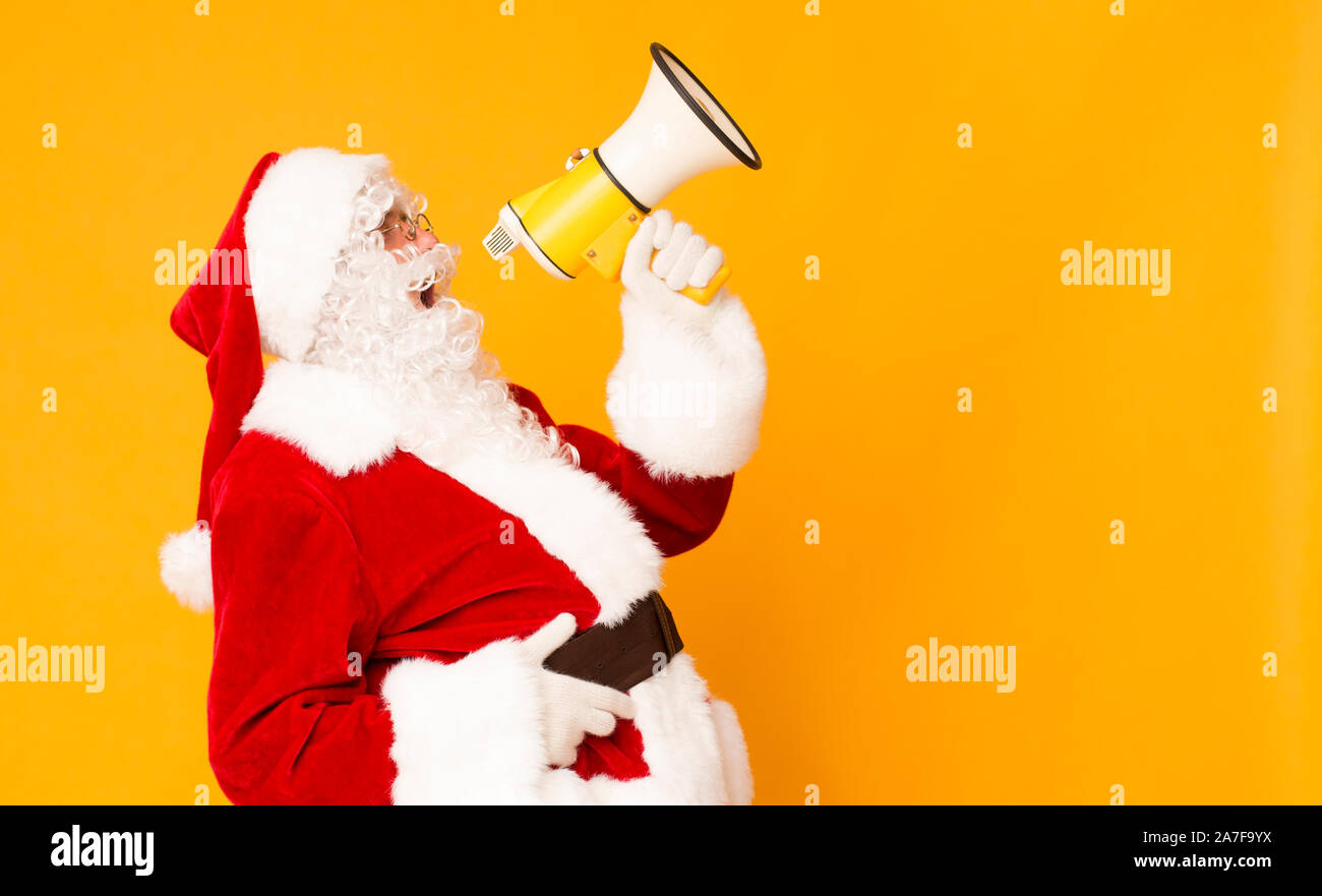 Creative Christmas background with Santa Claus and loudspeaker Stock