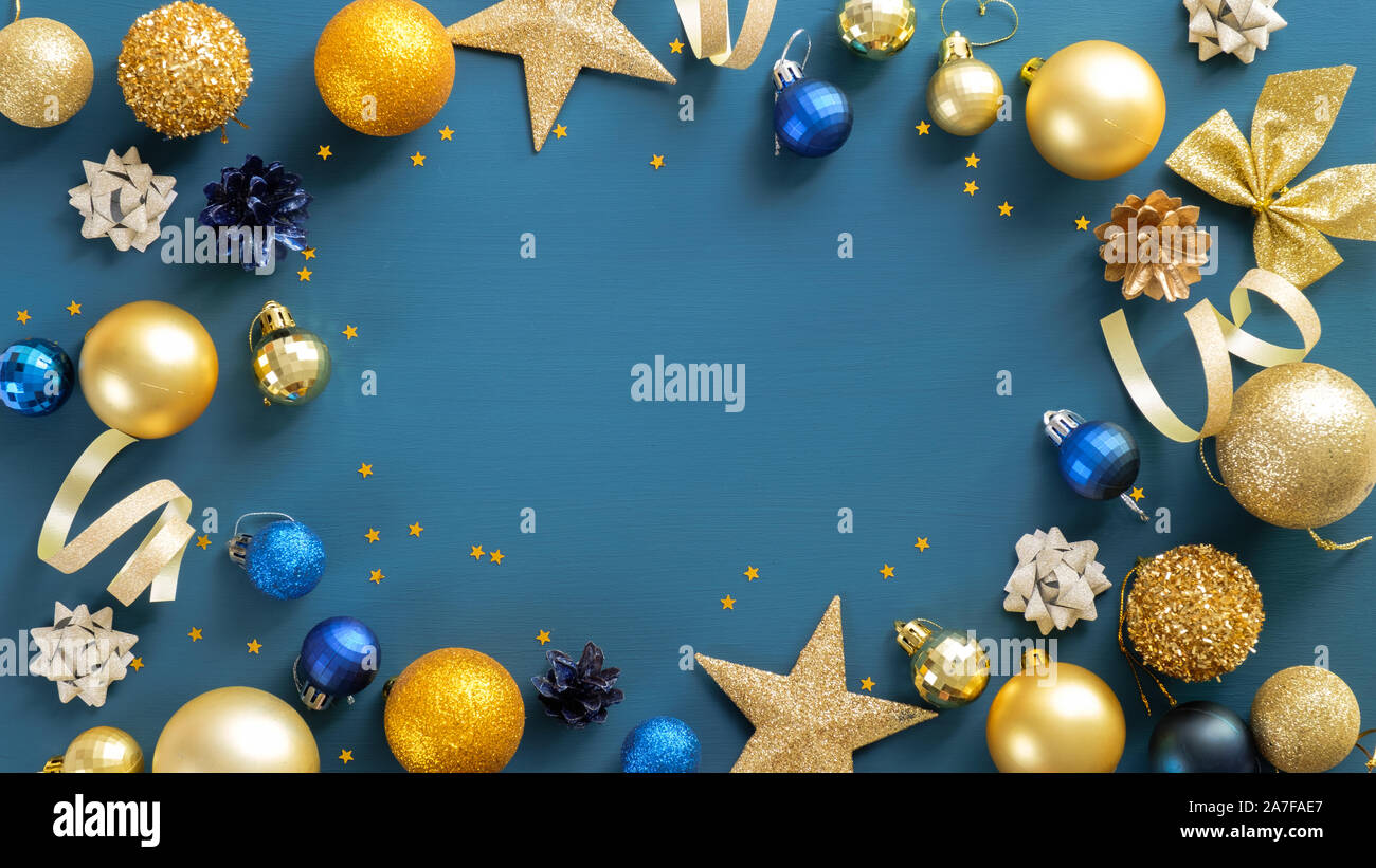 Christmas frame border with golden balls, stars, ribbon on blue background.  Flat lay, top view, copy space. Xmas banner mockup, flyer, poster template  Stock Photo - Alamy