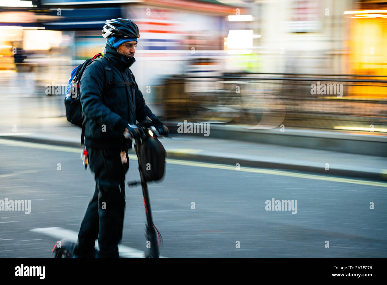 Man using electric scooter to escape the traffic in London UK Stock ...