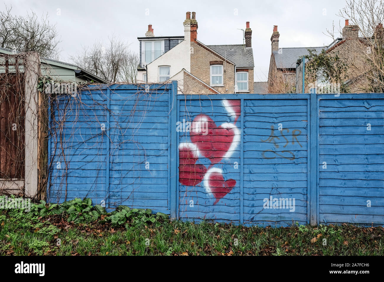 Love hearts painted on a fence in a park in Hitchin, Hertfordshire UK Stock Photo