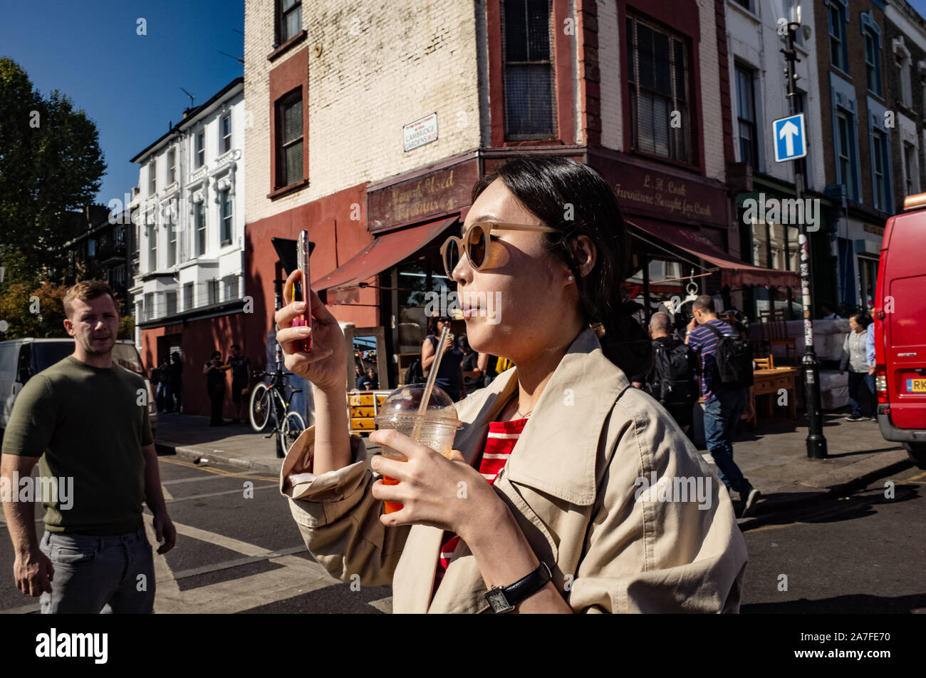 Selfie time at London's Portobello Road Market, London UK Stock Photo