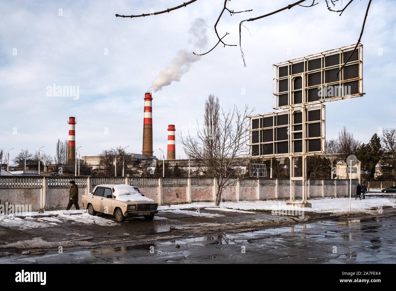 Winter time in Tiraspol the capital of Pridnestrovie or Transnistria. In the distance a water heating chimney can be seen bellowing smoke. Stock Photo