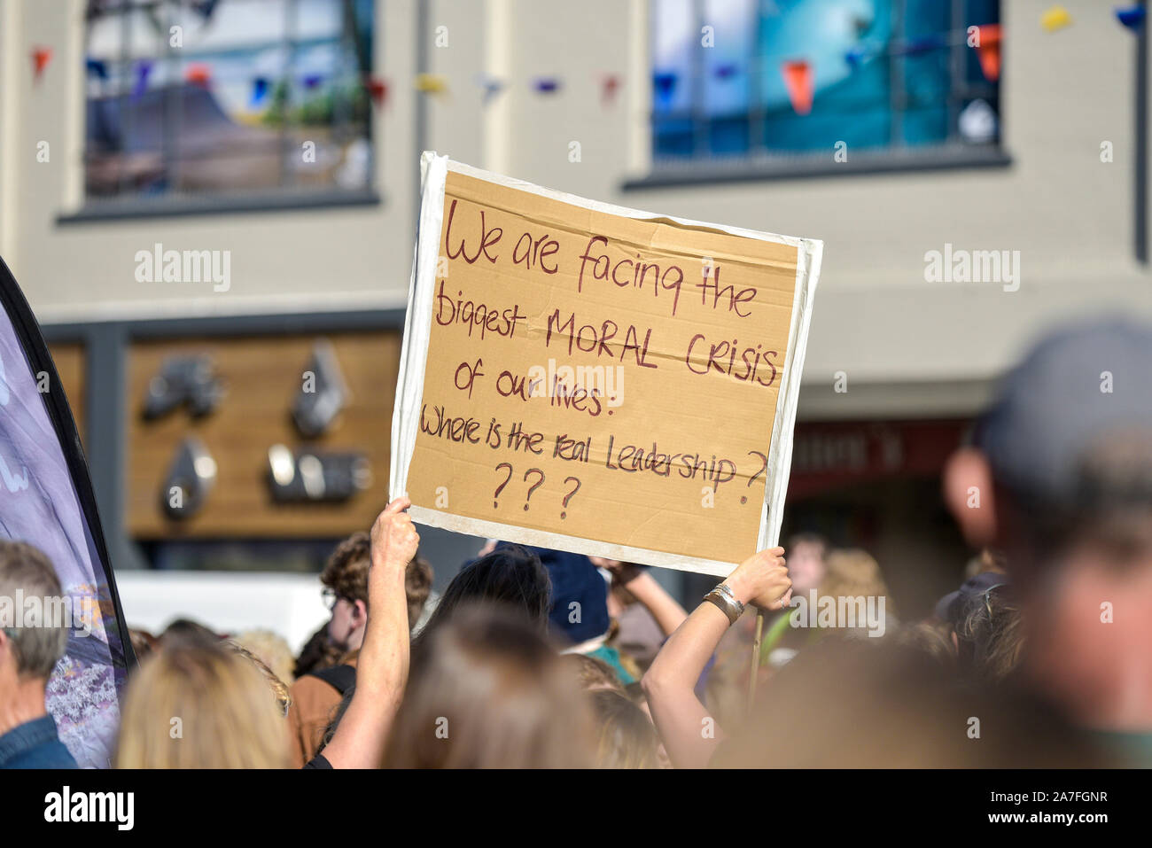 A handwritten cardboard placard held by protesters participating in the Extinction Rebellion climate strike in Truro City City in Cornwall. Stock Photo