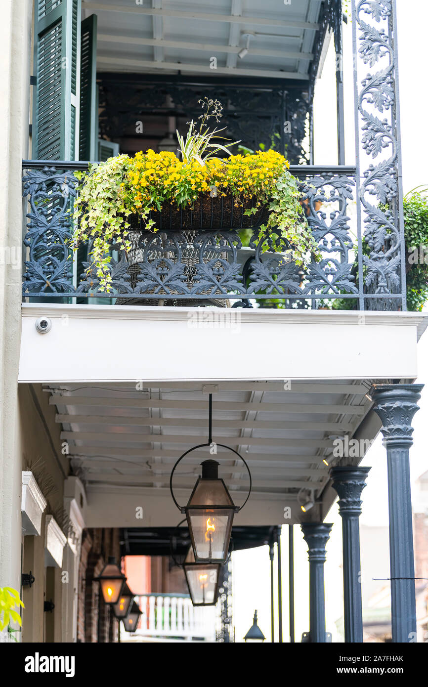 New Orleans street covered sidewalk with row on gas lanterns lamps in Louisiana and flower decorations Stock Photo