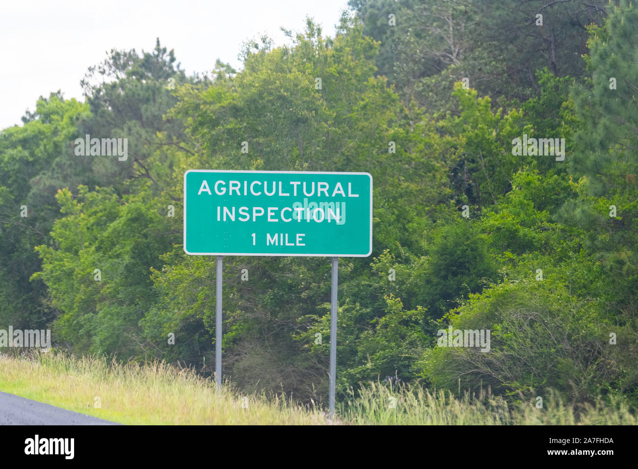 Mobile, Alabama city highway interstate 10 and closeup of sign for agricultural inspection station in one mile exit Stock Photo