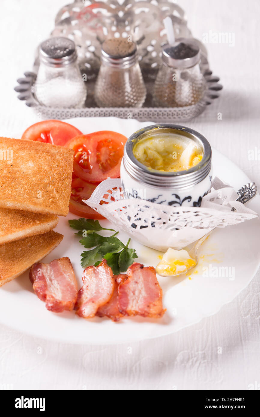 Breakfast with egg, bacon, croutons and coffee on the table Stock Photo