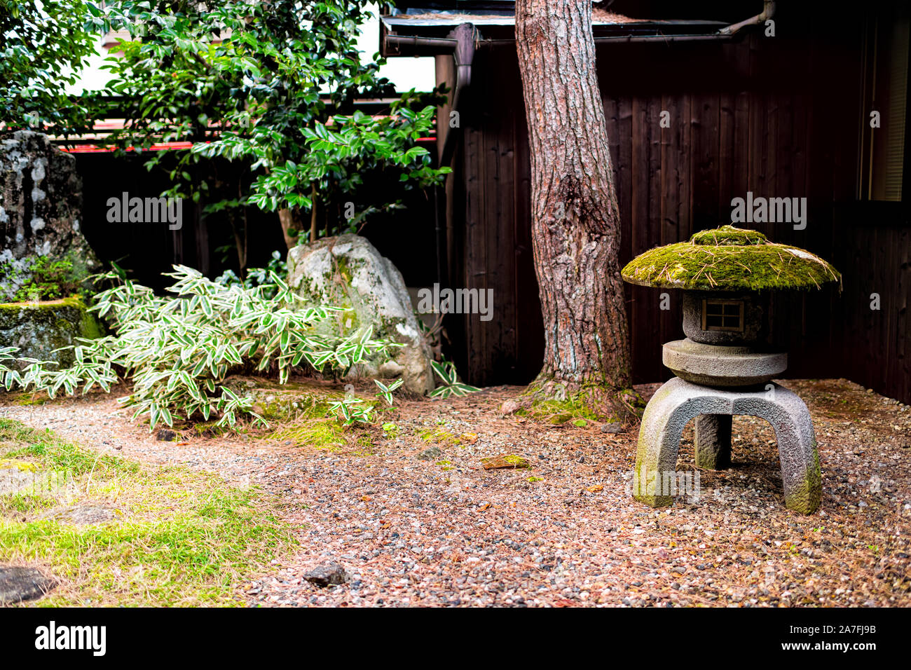 Traditional Japanese garden in Japan with small inside indoor with gravel stone rocks and lantern lamp at home or house Stock Photo