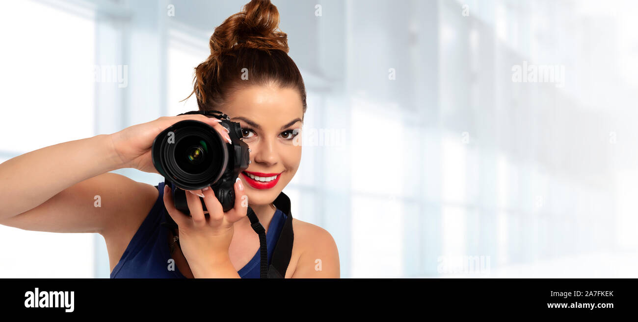 Photographer banner - beautiful and attractive woman holding a professional  DSLR camera and smiling (copy space Stock Photo - Alamy