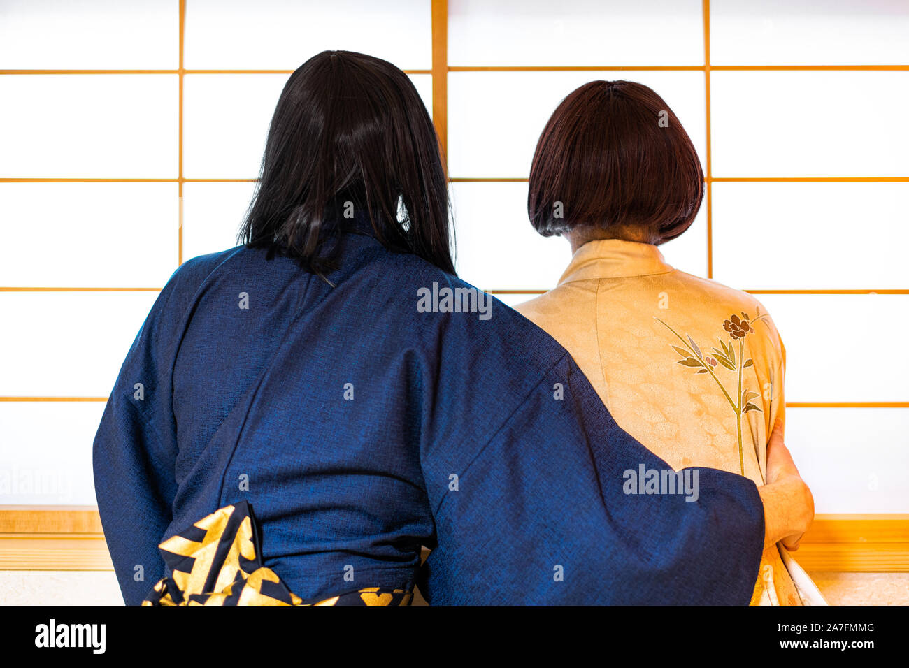 Traditional japanese house sliding door window with romantic woman and man couple in kimono costume standing Stock Photo