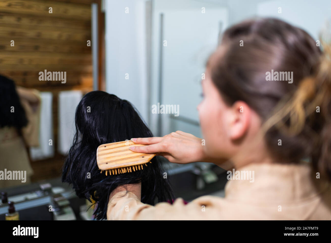 Young woman in kimono getting ready by traditional room brushing holding black wig in Japanese house home Stock Photo