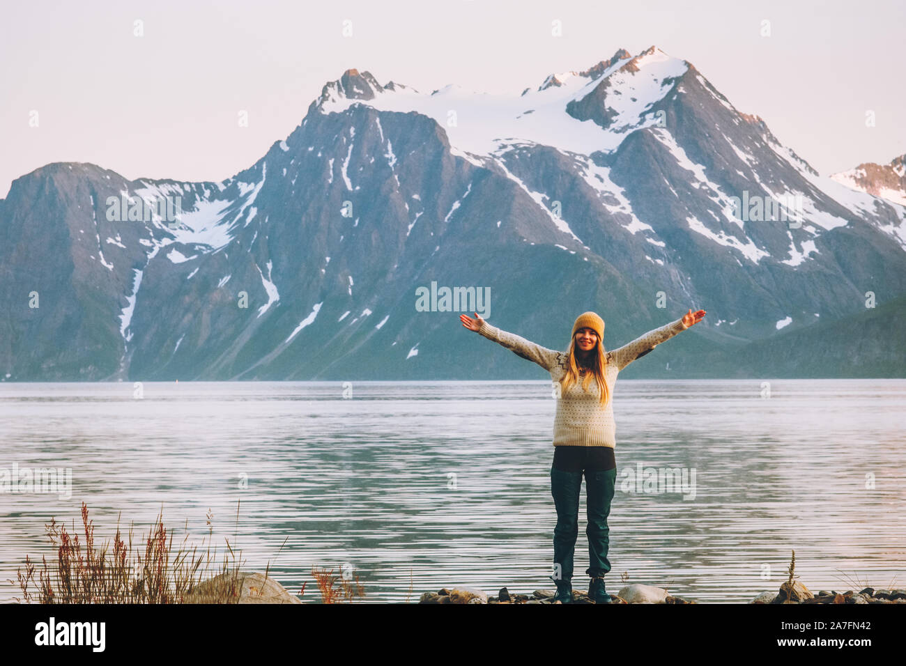 Happy woman hands raised enjoying  mountains landscape travel adventure vacations healthy lifestyle motivation Stock Photo