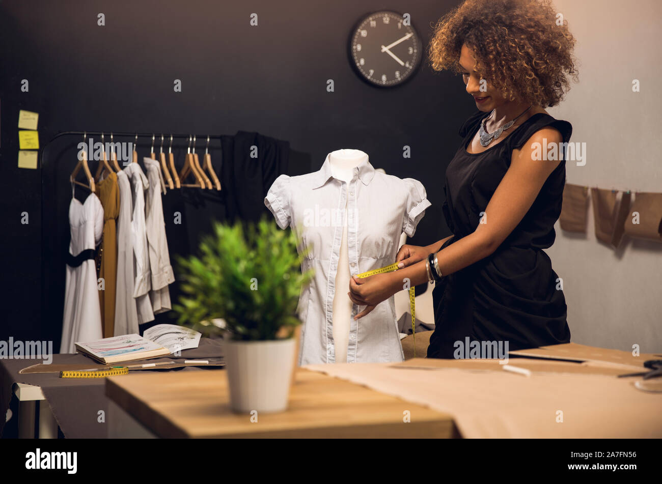 Young fashion designer working on her atelier Stock Photo - Alamy