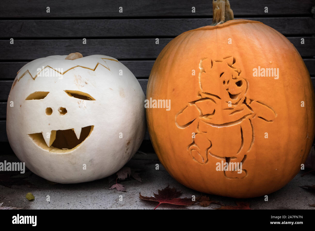 Two Halloween pumpkins, one represents Winnie-the-Pooh. Stock Photo