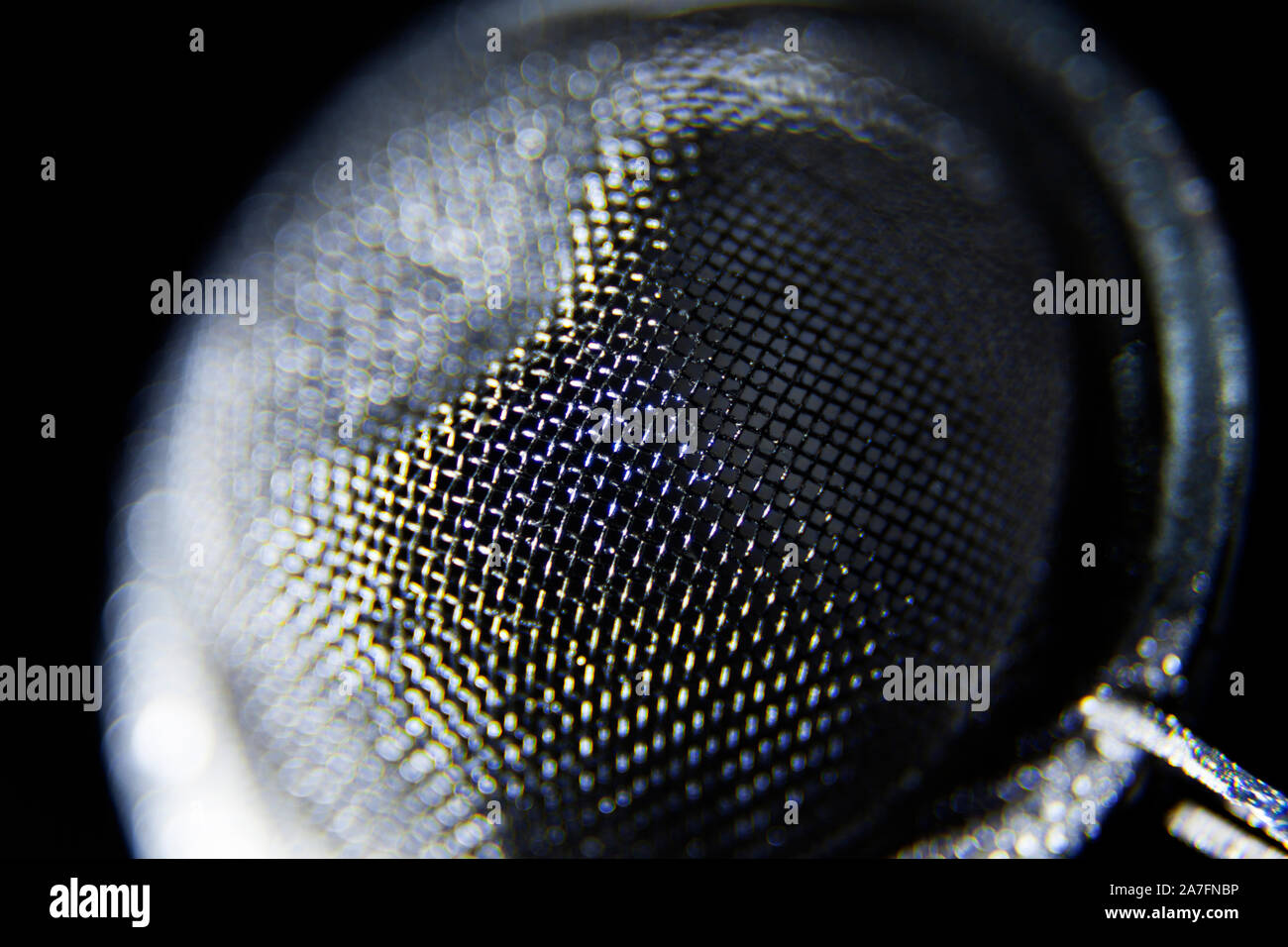 a tea strainer in close-up against black background Stock Photo