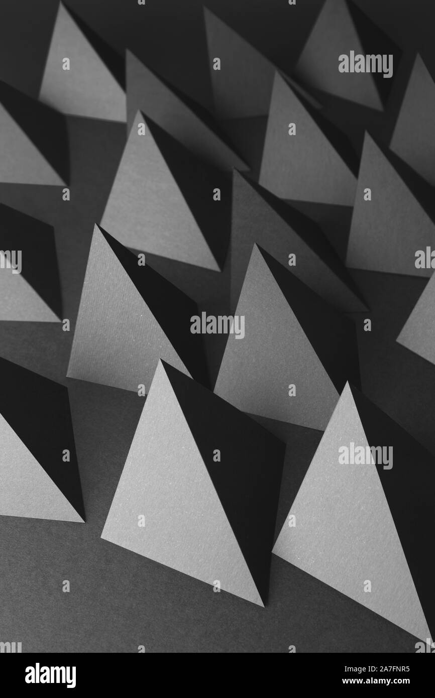 Pyramids of paper, dark abstract background Stock Photo - Alamy