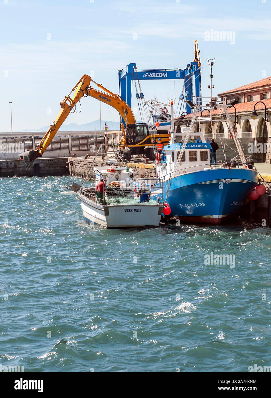 Harbor of Tarifa with boats and cranes Stock Photo