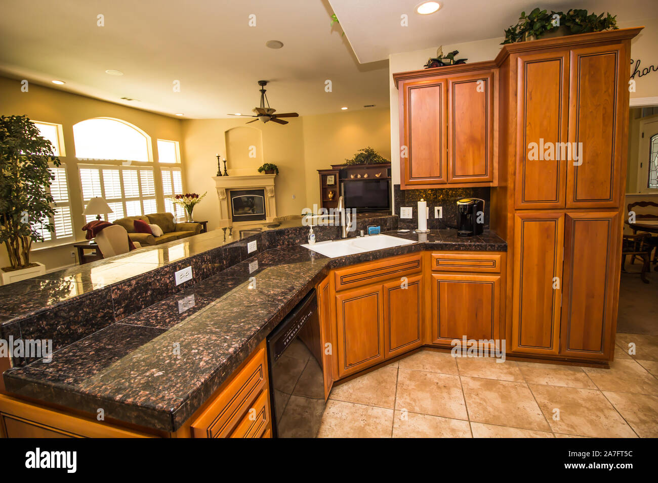 Modern Kitchen With Rich Wood Cabinets & Black Granite Counter Stock ...