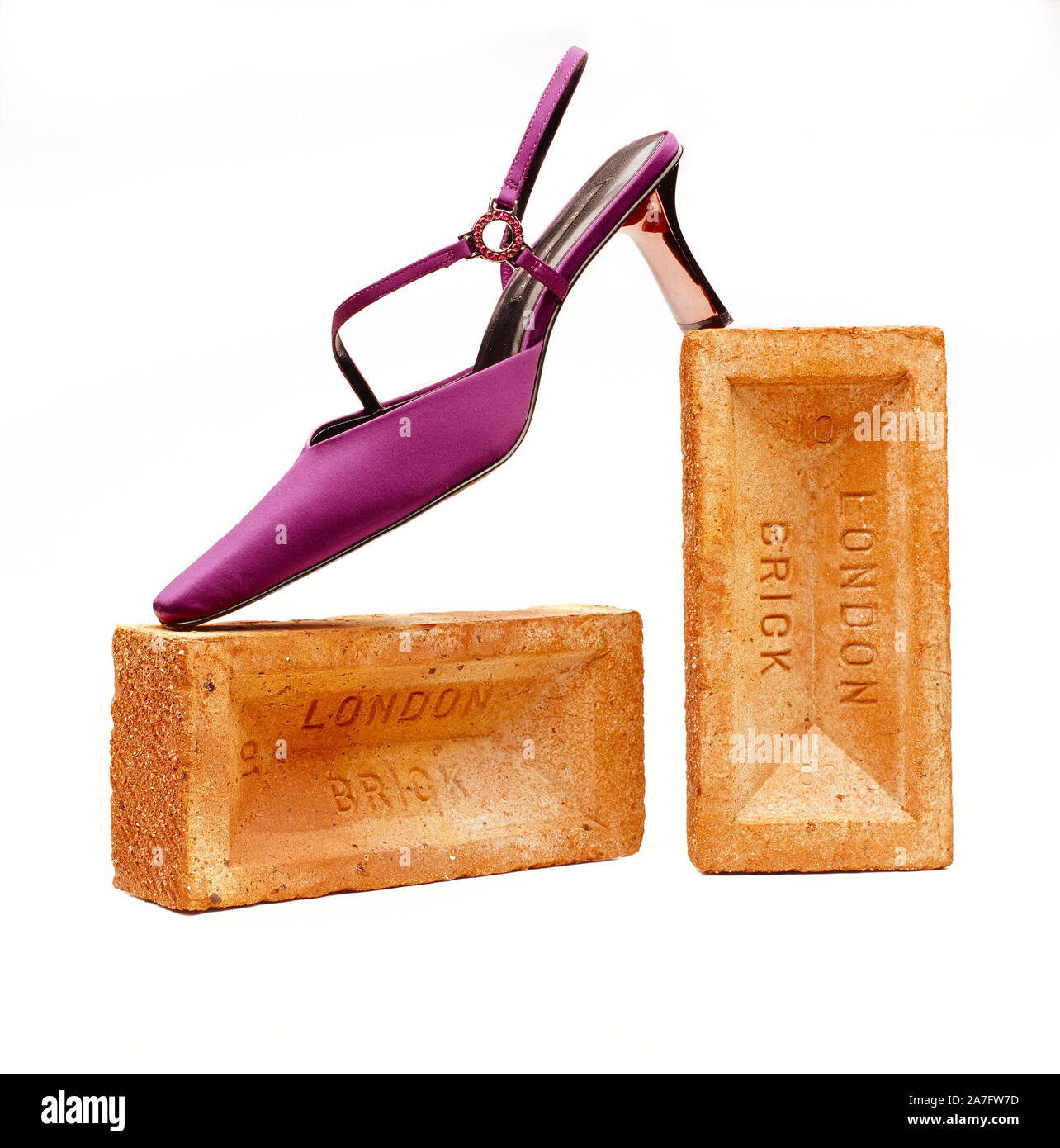 Still life. Studio image of fashion shoe posed with bricks. Stock Photo