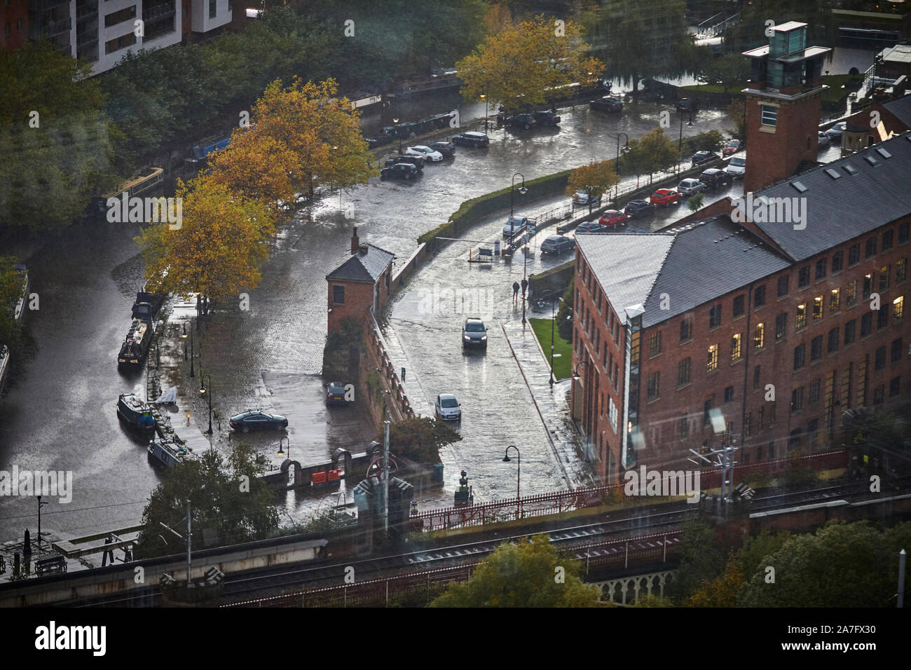Manchester Castlefiled castle Street and the Bridgewater Canal with Eastgate mill in the rain Stock Photo