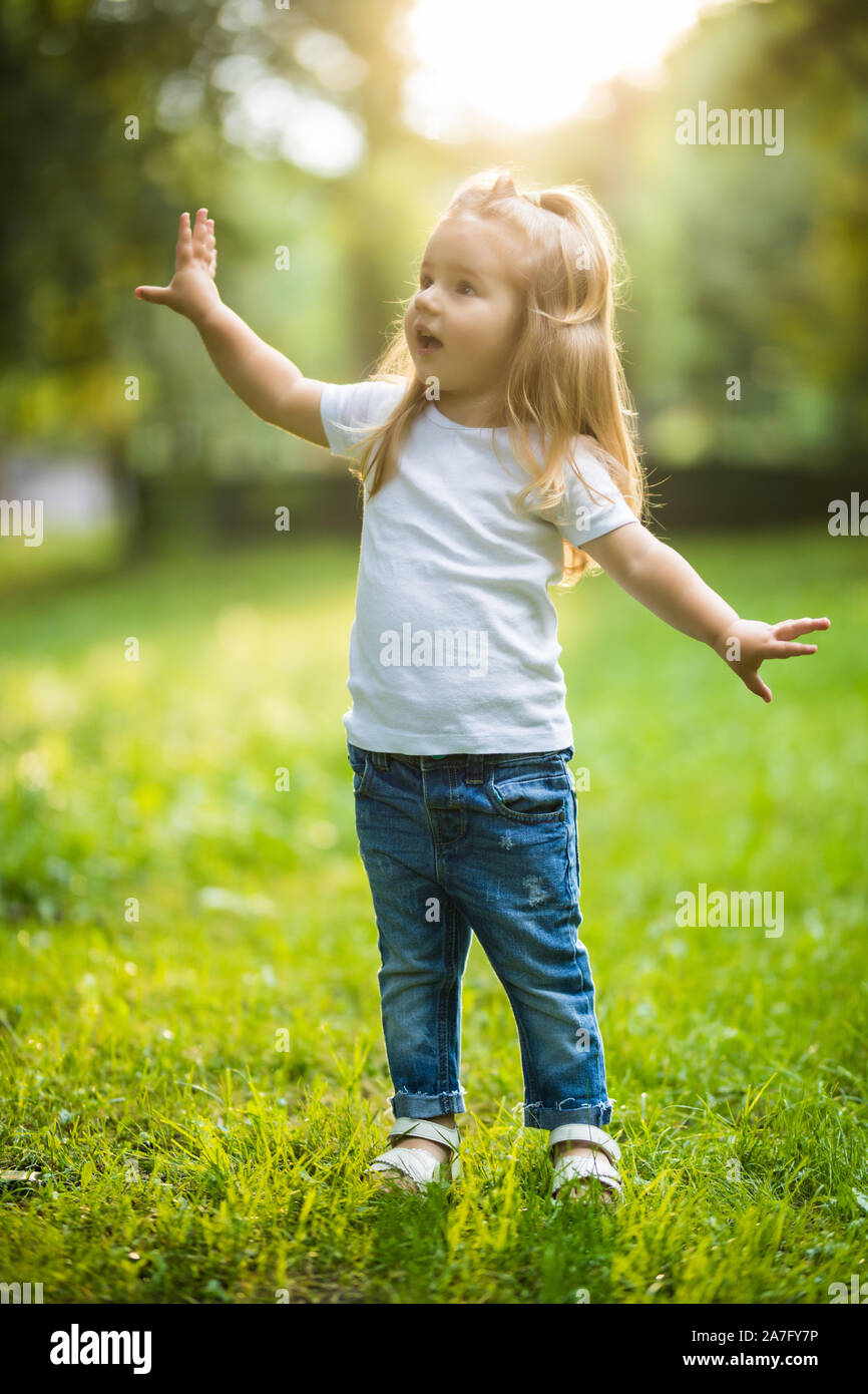 Little girl playing in the forest Stock Photo - Alamy