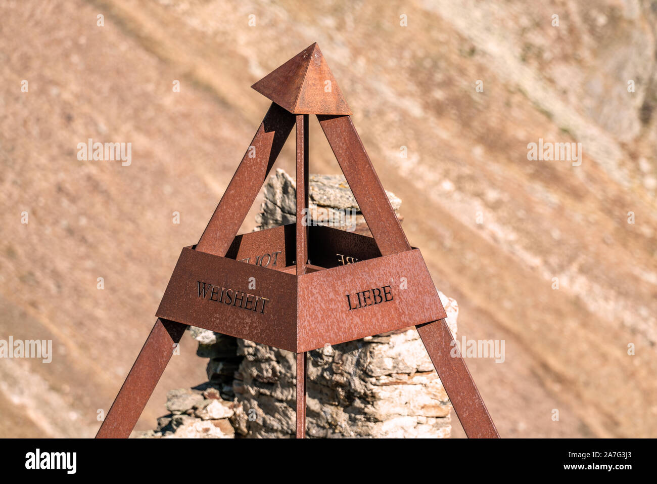 Outddors artwork made of iron shaped like a pyramid with inscribed words LOVE and WISDOM Stock Photo
