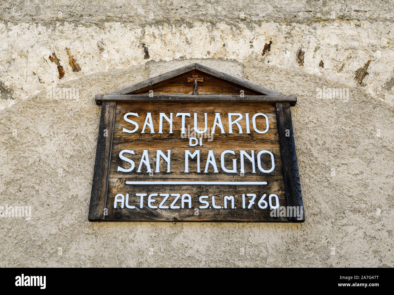 Close-up of the wooden sign on the façade of the sanctuary of Saint Magno (1475), Castelmagno, Grana Valley, Cuneo, Piedmont, Italy Stock Photo