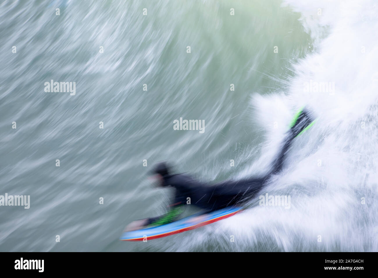 A bodyboarder rides a wave at Porthleven, Cornwall Stock Photo