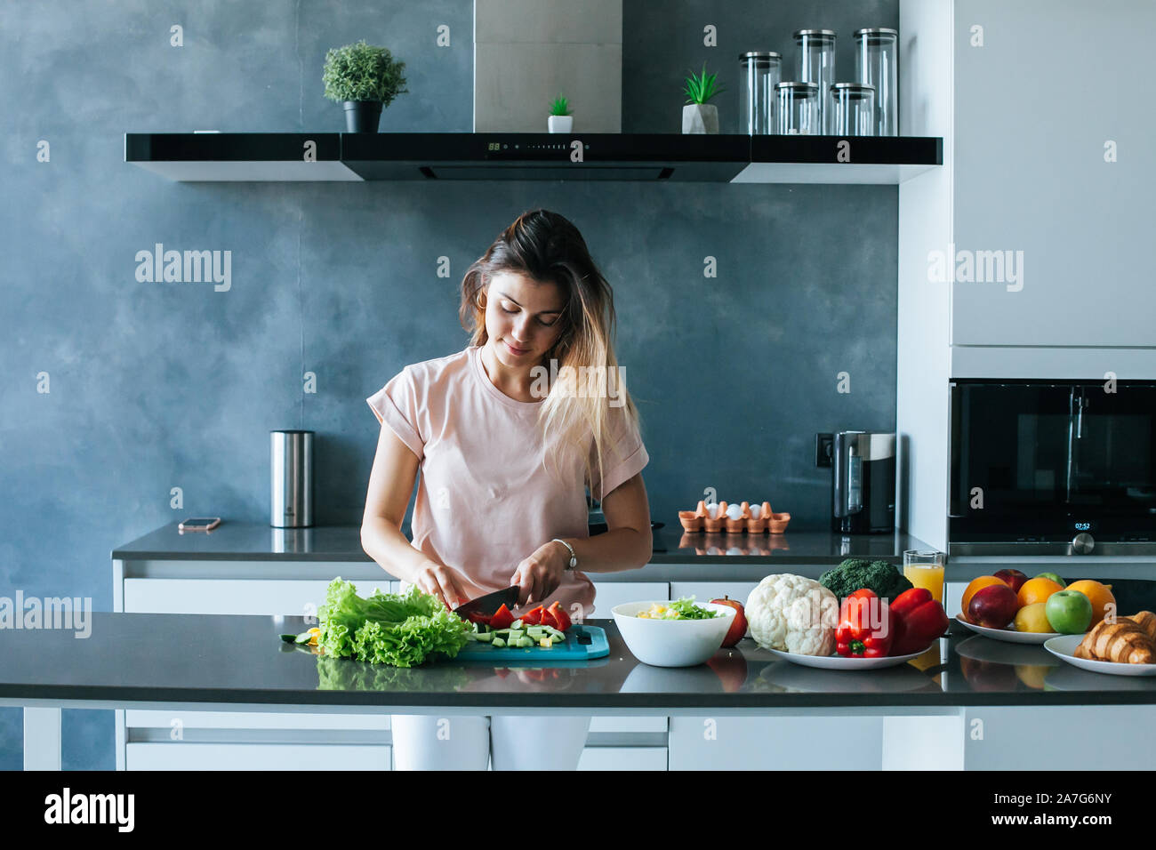 Image showcasing Woman with healthy food in the kitchen Stock Photo - Alamy